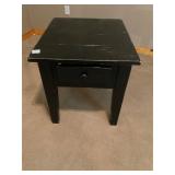 Black wooden end table with drawer