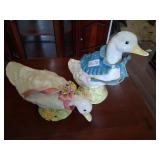 a couple vintage geese figurines