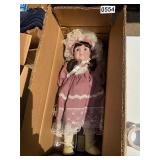 Porcelain doll in mauve dress
