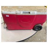 Red coleman ice chest/cooler on wheels