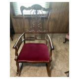 Antique wooden rocking chair with fabric seat