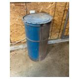 Metal barrel. Lid. 1/4 full floor oil dry