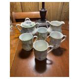Floral teacups, sugar, creamer