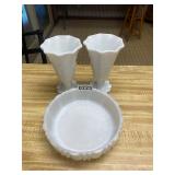 Two white vases with round white dish