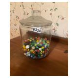 Large glass canister of marbles
