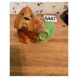 Shawnee puppy leaning on jug planter