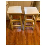 2- white wooden bar stools