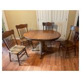 Oak pedestal table, four chairs, and leaf