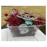 Tote full of red and green decorations and decor