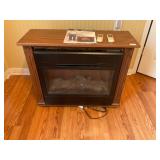 Heat surge electric fireplace with remote