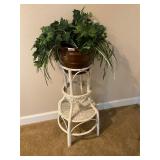 White wicker plant stand with greenery