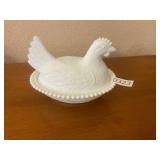 White milk, glass hen on the nest