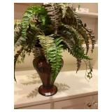 Red ornate vase with greenery