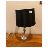 Silver table, lamp, black shade