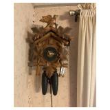 Vintage wooden cuckoo clock with weights