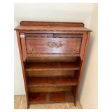 Antique wooden bookshelf with fold down door