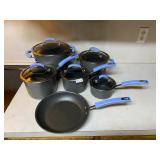 Blue handled Rachael Ray pots and pans