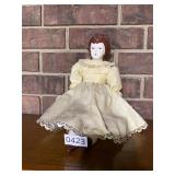 Tight lipped lady in yellow doll