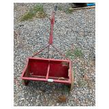Red metal seeder cart