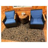 2- black and blue patio chairs, rug, and table