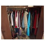 Closet of women's heavy coats and umbrellas