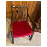 Vintage wooden chair covered in red fabric
