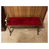 Wrought iron bench with red cover