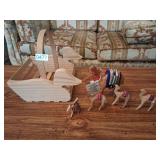 Hand carved wooden camels in a wooden duck baskket