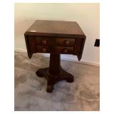 Wood pedestal table with drawers