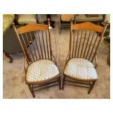 Two wooden chairs with fabric seats