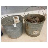 2 galvanized buckets and barbed wire