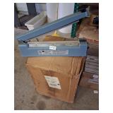large impulse sealer and box of plastic rolls