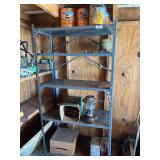 Metal shelf and contents, including Coleman oil lamp, grill rocks, paint