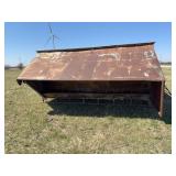 14 ft metal cattle feeder on skids, damaged