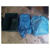 Two Blue Tarps in a Green Tote