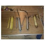Four Handheld Grease Guns