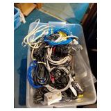 Bin of Mixed Charging Cables and Plugs