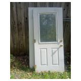 Two White Exterior Doors With Glass Insets