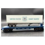 White Lionel O-scale model flatcar decorated for