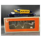 blue and yellow Lionel 6-36021 O Gauge Flatcar