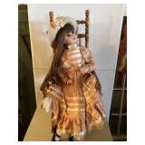 Porcelain Doll In Rocker