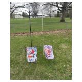 Two Shepherd hooks and two holiday flags with