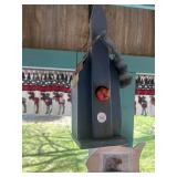 Wooden birdhouse with metal roof