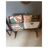 Quilt rack with various linens including basket