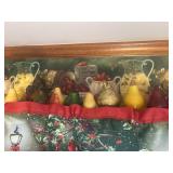 Several pear paperweights on shelf above window