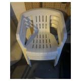 Four plastic stack on chairs
