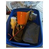 A tote with buckets, jars, cooler, basket, corn