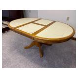 Tile top dining table with disappearing leaf