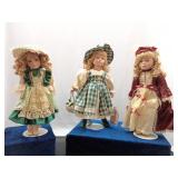 3 Porcelain dolls with stands