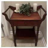 Vintage side table with faux plant and candles,